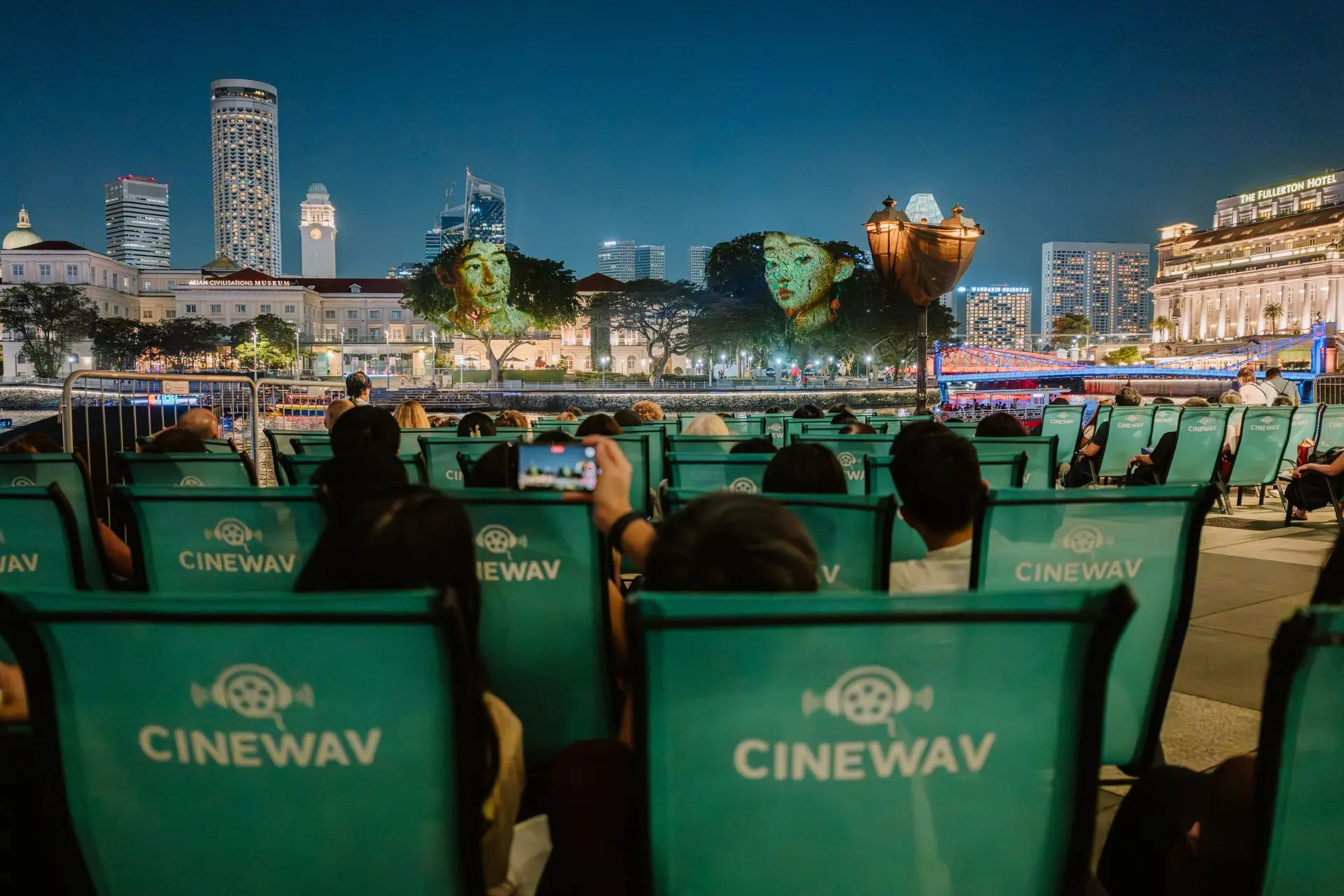 hundreds of people watching a musical rendition of Singapore River's history with immersive audio